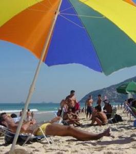 Families on the beach, relaxing under an umbrella