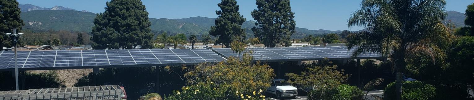 Solar power aray as seen over the parking lot past the pool